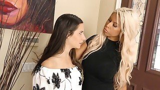 Blonde dominatrix is playing with a brunette